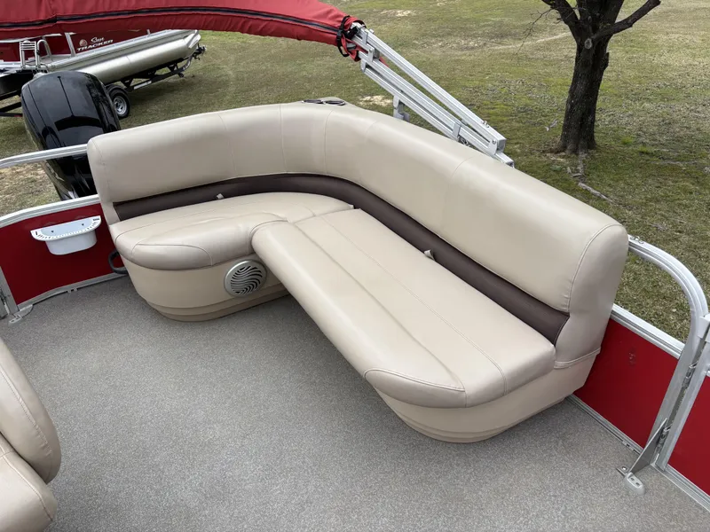 Slide: The Image of 2017 Sun Tracker Party Barge 18 DLX with beige seating and red accents. - 11