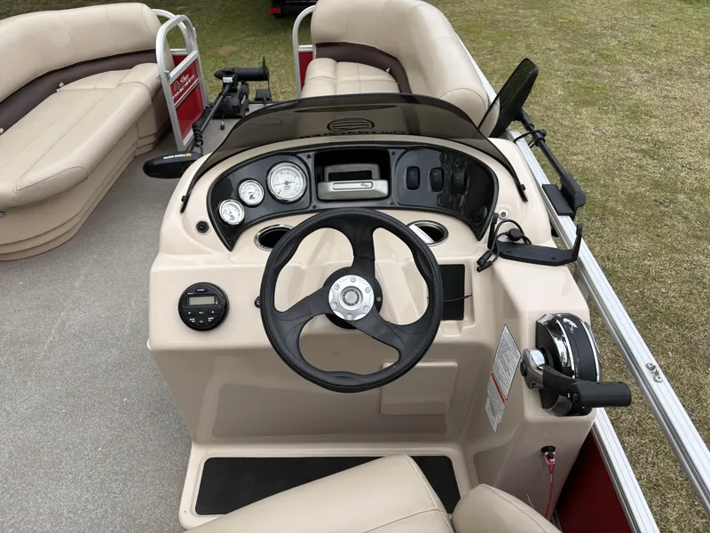 Slide: The Image of 2017 Sun Tracker Party Barge 18 DLX steering console with gauges and controls. - 13