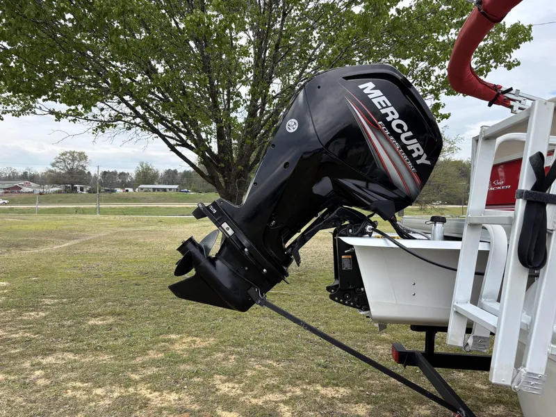 Slide: The Image of 2017 Sun Tracker Party Barge 18 DLX with Mercury outboard motor in a grassy area. - 6