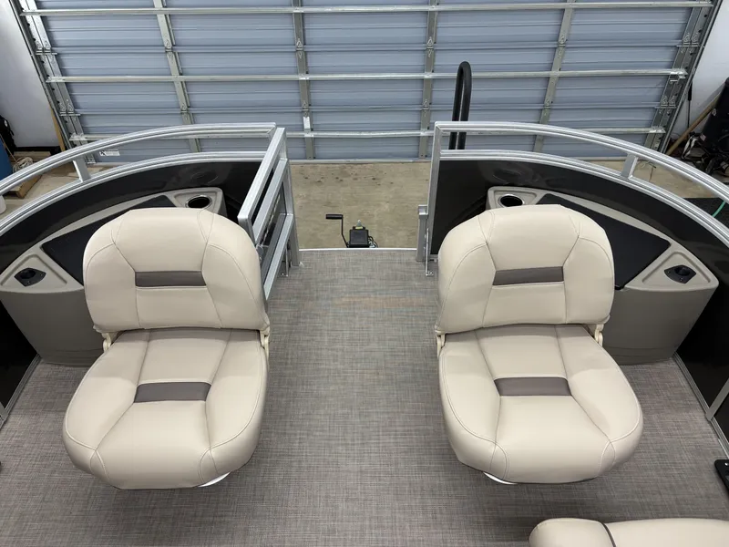 Slide: The Image of 2025 Sun Tracker Fishin Barge 20 DLX interior with beige seating and modern design. - 10