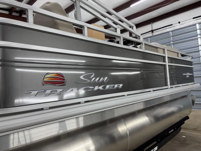Slide: The Image of 2025 Sun Tracker Fishin Barge 20 DLX pontoon boat in a storage facility. - 13