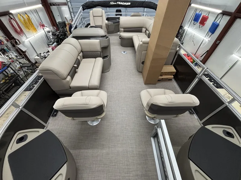 Slide: The Image of 2025 Sun Tracker Fishin Barge 20 DLX interior with beige seating and spacious layout. - 15