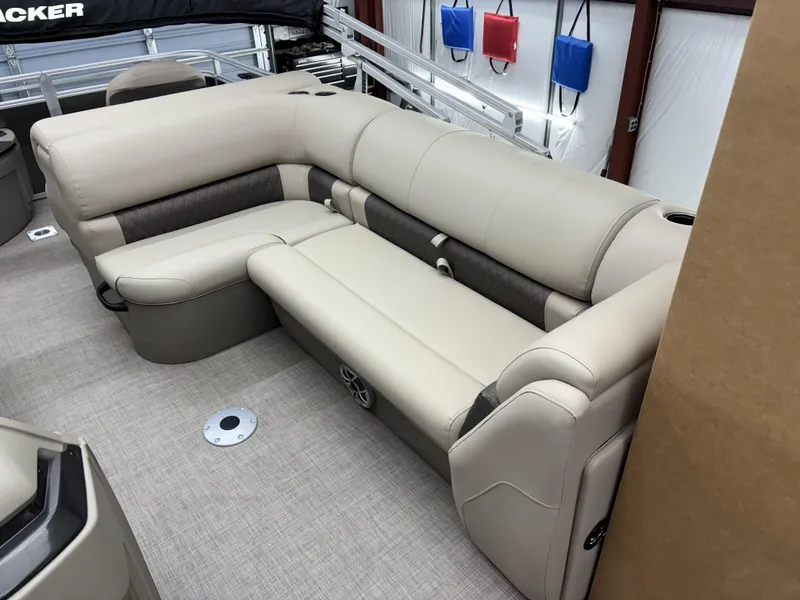 Slide: The Image of 2025 Sun Tracker Fishin Barge 20 DLX interior with beige seating and modern design. - 6