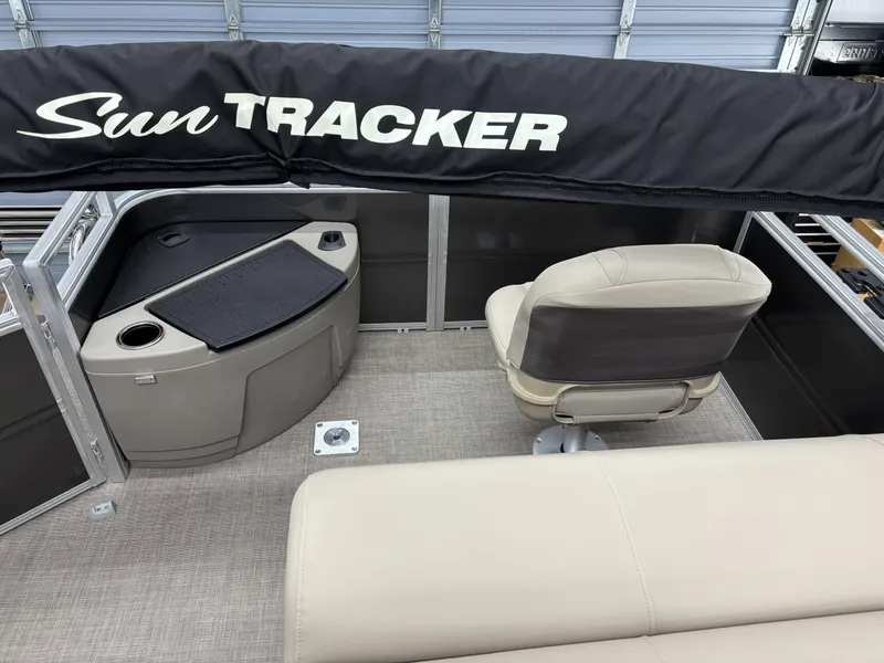 Slide: The Image of 2025 Sun Tracker Fishin Barge 20 DLX interior with seating and console. - 7