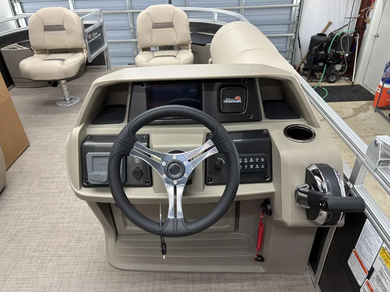 Slide: The Image of 2025 Sun Tracker Fishin Barge 20 DLX helm with steering wheel and controls. - 9