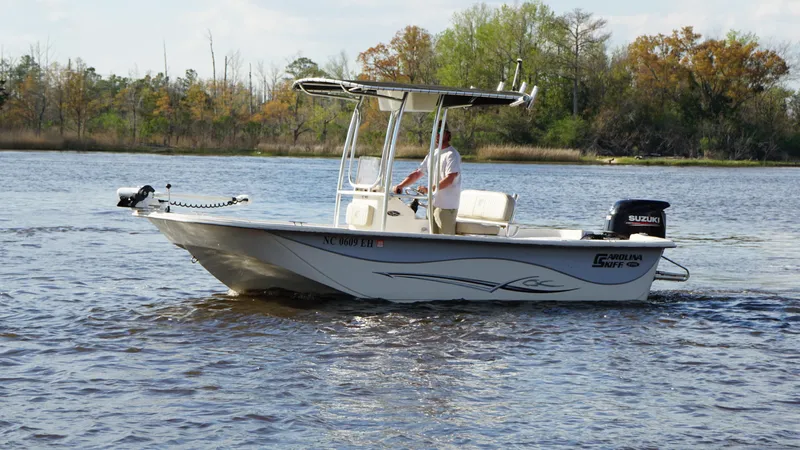 Slide: The Image of 2018 Carolina Skiff 198DLV boat cruising on a calm river. - 1