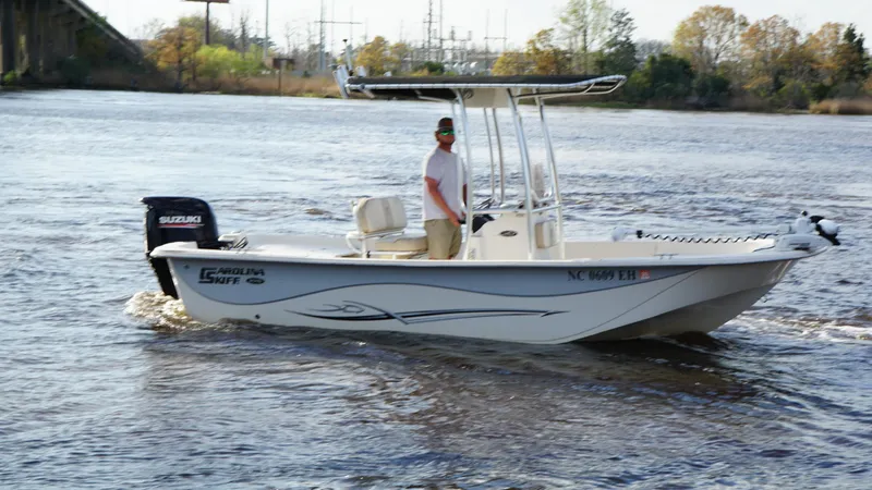 Slide: The Image of 2018 Carolina Skiff 198DLV boat cruising on a river with a person onboard. - 4