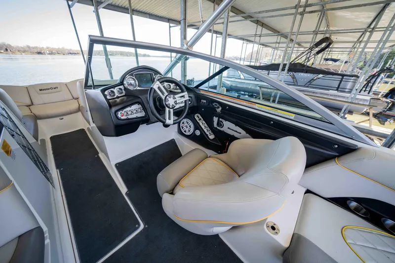 Slide: The Image of 2010 MasterCraft X25 boat interior with modern dashboard and comfortable seating. - 11