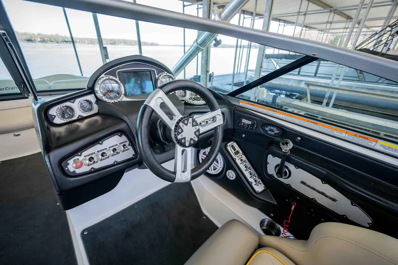 Slide: The Image of 2010 MasterCraft X25 boat interior with steering wheel and dashboard controls. - 12