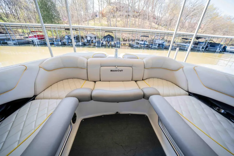 Slide: The Image of 2010 MasterCraft X25 boat interior with plush seating and scenic marina view. - 13