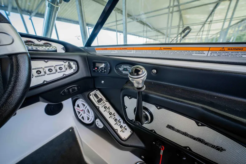 Slide: The Image of 2010 MasterCraft X25 boat dashboard with controls and steering wheel. - 20