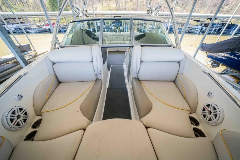 Slide: The Image of 2010 MasterCraft X25 boat interior with white seating and speaker system. - 26