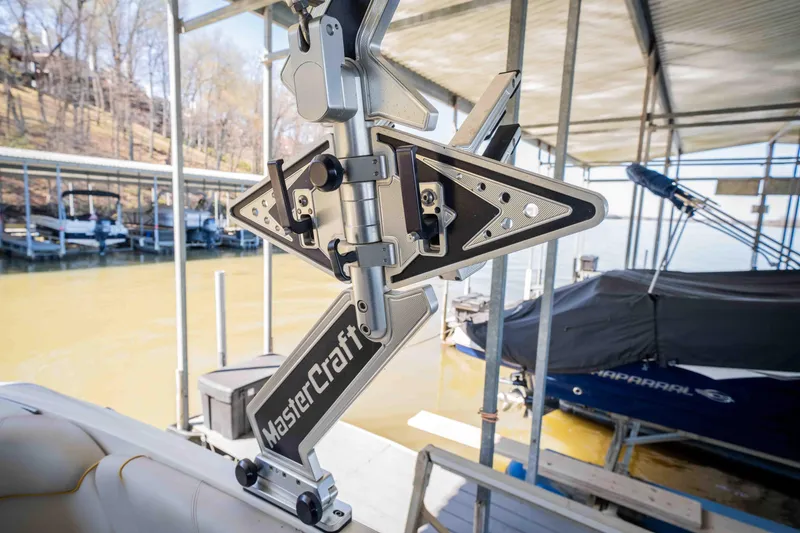 Slide: The Image of 2010 MasterCraft X25 wakeboard rack on a docked boat. - 28