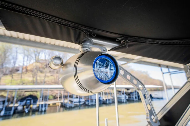Slide: The Image of 2010 MasterCraft X25 boat spotlight under canopy at marina. - 29