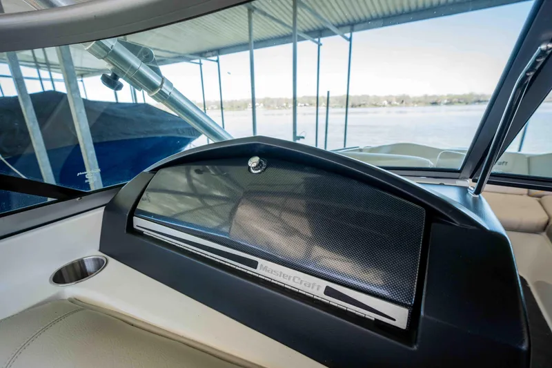 Slide: The Image of 2010 MasterCraft X25 dashboard with lake view in background. - 31
