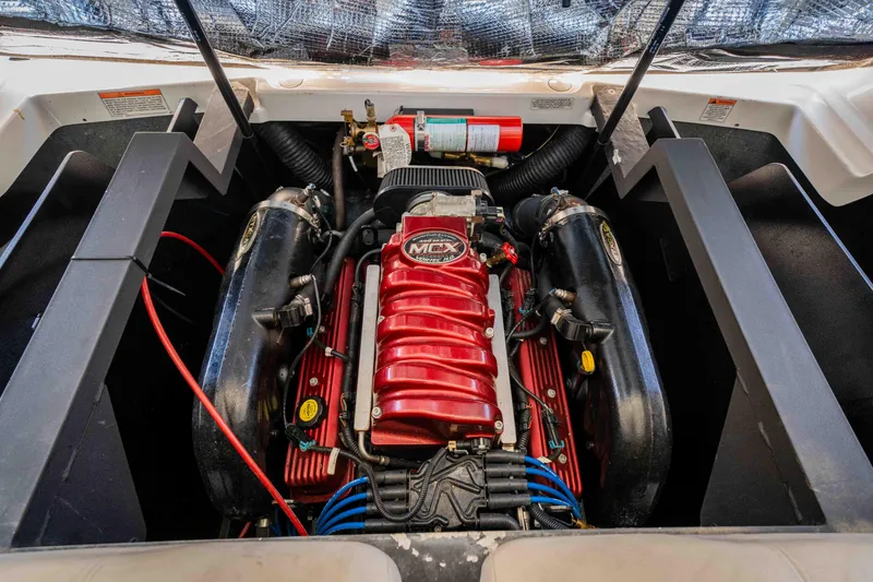 Slide: The Image of 2010 MasterCraft X25 engine compartment with red MCX engine and fire extinguisher. - 34