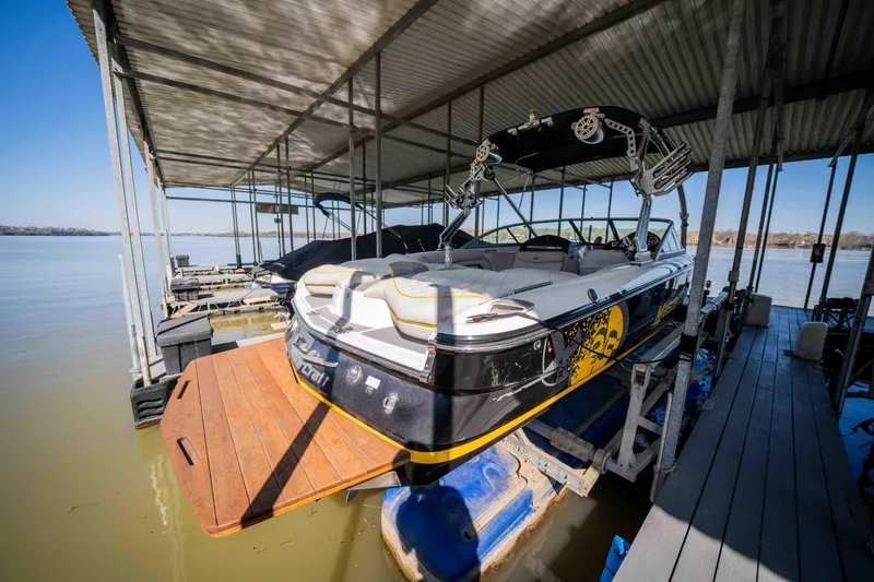 Slide: The Image of 2010 MasterCraft X25 boat docked under a covered marina. - 5