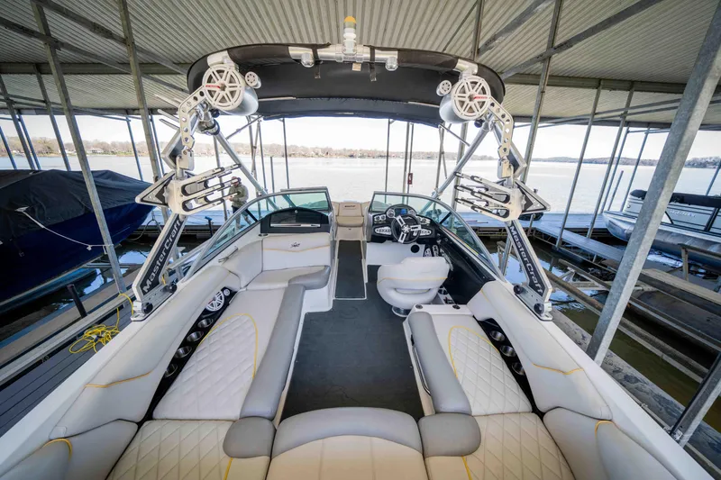 Slide: The Image of 2010 MasterCraft X25 boat interior with spacious seating and advanced audio system. - 9
