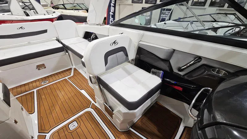 Slide: The Image of 2016 Monterey 258 Super Sport boat interior with white seating and wood flooring. - 10