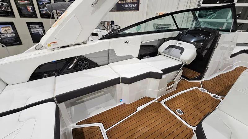 Slide: The Image of 2016 Monterey 258 Super Sport boat interior with sleek seating and wooden flooring. - 11