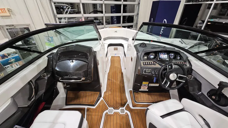 Slide: The Image of 2016 Monterey 258 Super Sport boat interior with sleek dashboard and wood flooring. - 14