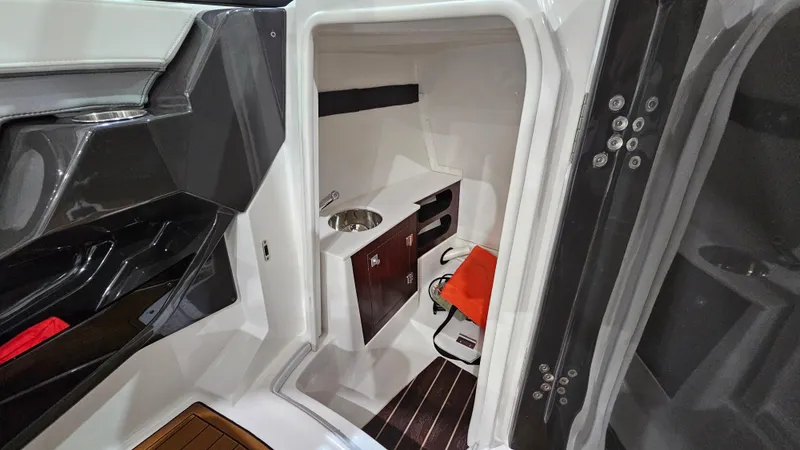 Slide: The Image of 2016 Monterey 258 Super Sport boat interior with compact cabin and sink. - 15