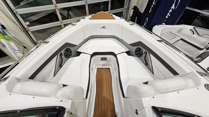 Slide: The Image of 2016 Monterey 258 Super Sport boat interior with white seating and wood accents. - 16