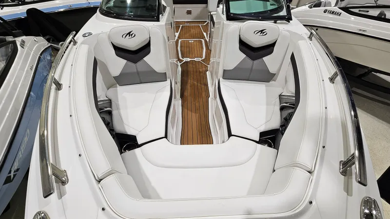 Slide: The Image of 2016 Monterey 258 Super Sport boat interior with white seating and wood accents. - 17