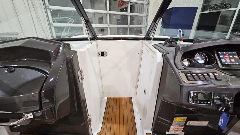 Slide: The Image of Interior view of a 2016 Monterey 258 Super Sport boat cockpit with wood flooring. - 20