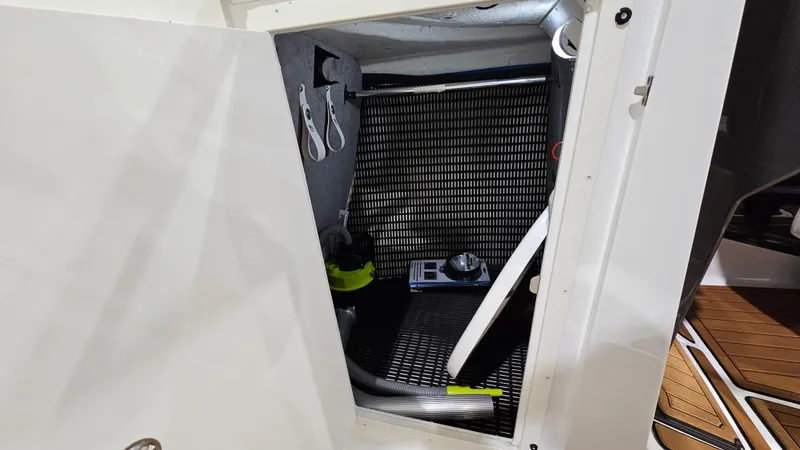 Slide: The Image of Storage compartment inside 2016 Monterey 258 Super Sport boat, featuring various equipment and accessories. - 21