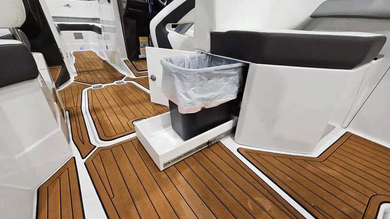 Slide: The Image of 2016 Monterey 258 Super Sport interior with wood flooring and built-in trash compartment. - 24