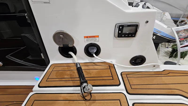 Slide: The Image of 2016 Monterey 258 Super Sport boat deck with teak flooring and control panel. - 25