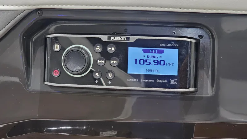 Slide: The Image of Fusion marine stereo system on a 2016 Monterey 258 Super Sport, displaying FM 105.90 MHz. - 26