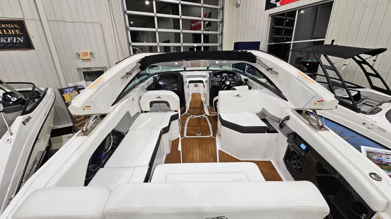 Slide: The Image of 2016 Monterey 258 Super Sport boat interior with white seating and wood accents. - 28