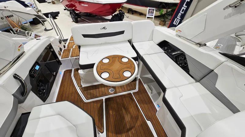 Slide: The Image of 2016 Monterey 258 Super Sport boat interior with white seating and wooden accents. - 29