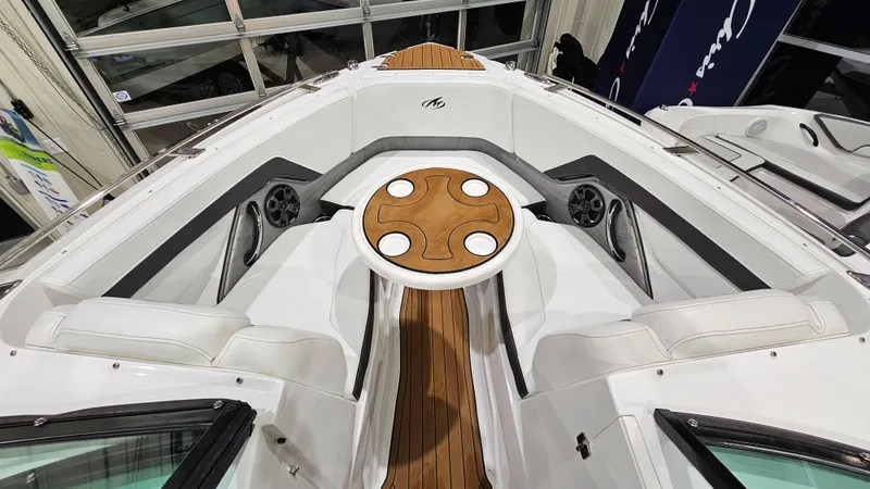 Slide: The Image of 2016 Monterey 258 Super Sport boat interior with wood accents and seating area. - 30