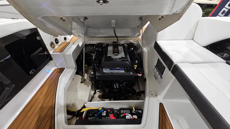 Slide: The Image of 2016 Monterey 258 Super Sport boat engine compartment with open hatch and visible components. - 32