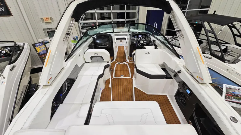 Slide: The Image of 2016 Monterey 258 Super Sport boat interior with white seating and wood flooring. - 7