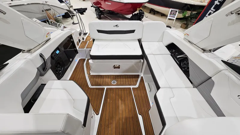 Slide: The Image of 2016 Monterey 258 Super Sport boat interior with white seating and wood flooring. - 9