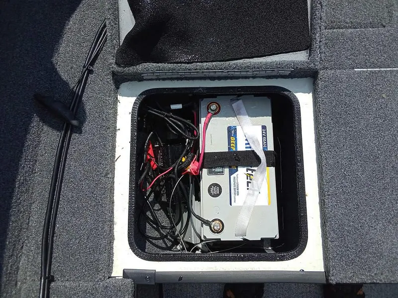 Slide: The Image of 2022 Ranger VS1665T boat battery compartment with secured battery and wiring. - 10