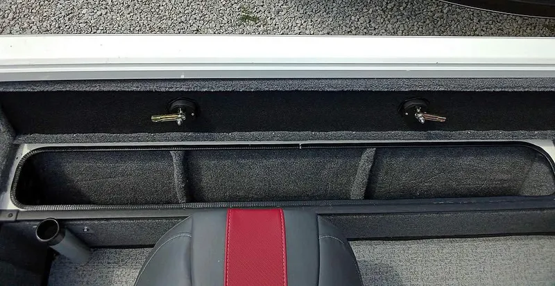 Slide: The Image of 2022 Ranger VS1665T boat interior storage compartment with red and gray seating. - 15
