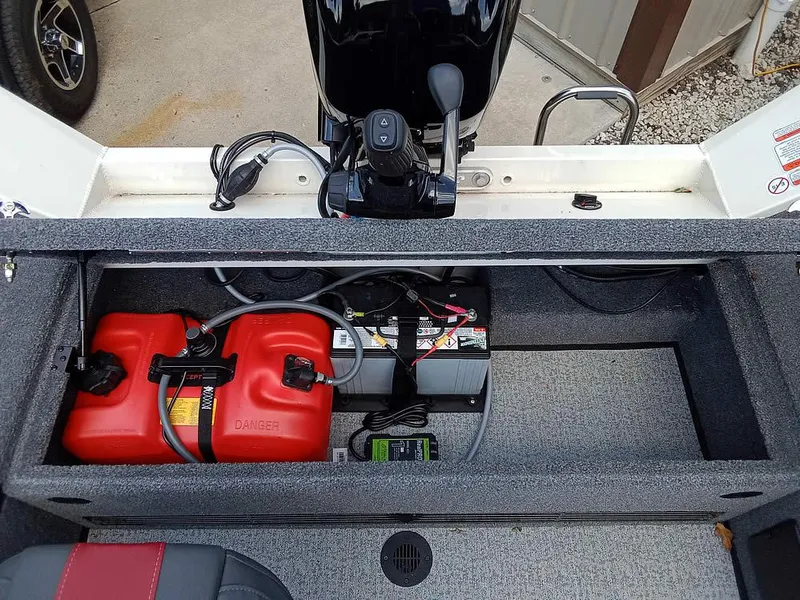 Slide: The Image of 2022 Ranger VS1665T boat storage compartment with fuel tank and battery setup. - 17