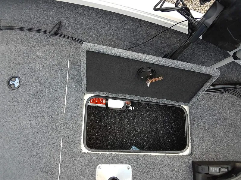 Slide: The Image of 2022 Ranger VS1665T boat storage compartment with open hatch, revealing interior details. - 7