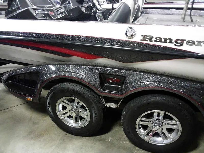 Slide: The Image of 2019 Ranger Z520L Comanche DC boat with dual axle trailer, sleek design, and metallic accents. - 10