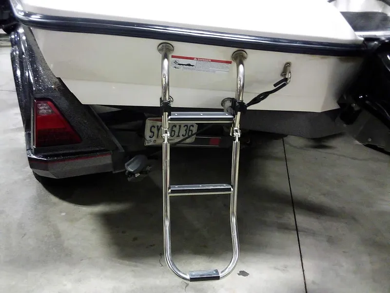 Slide: The Image of 2019 Ranger Z520L Comanche DC boat with rear ladder and trailer in a garage. - 11