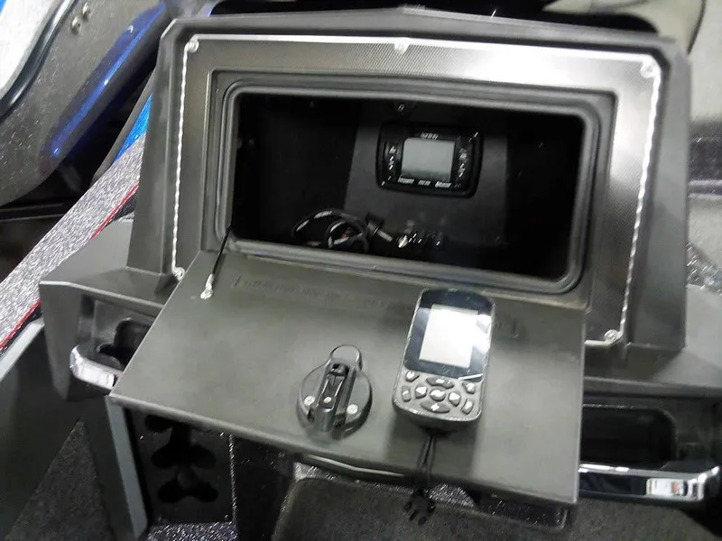 Slide: The Image of 2019 Ranger Z520L Comanche DC boat dashboard with electronic devices and storage compartment. - 26
