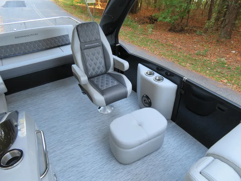 Slide: The Image of 2020 Bennington 25QXSBWAIO boat interior with luxury seating and cup holders. - 12
