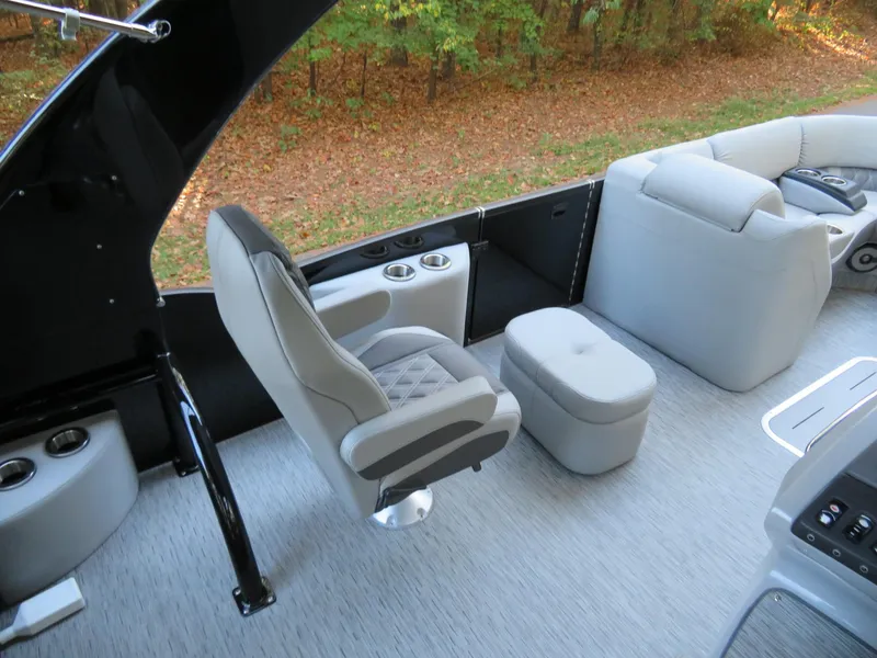 Slide: The Image of 2020 Bennington 25QXSBWAIO boat interior with plush seating and cup holders. - 13