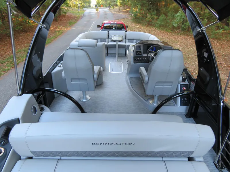 Slide: The Image of 2020 Bennington 25QXSBWAIO pontoon boat interior with gray seating and steering console. - 16