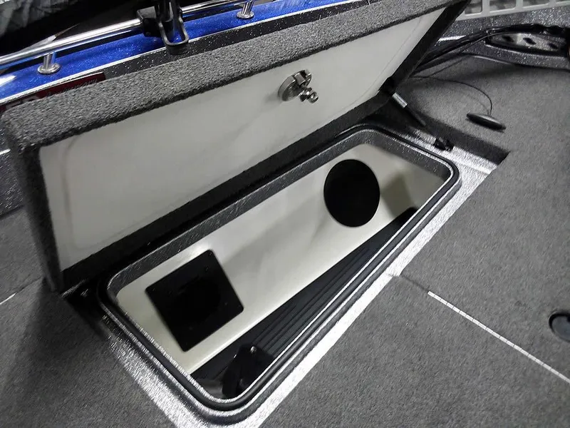 Slide: The Image of Open storage compartment in 2018 Ranger 621FS Fisherman boat, featuring carpeted interior. - 11